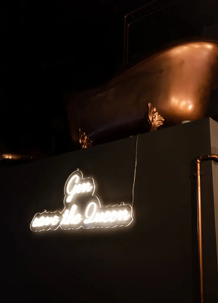gin save the queen and a large bronze bathtub